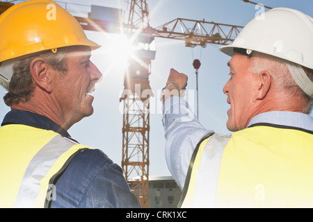 Workers talking on construction site Stock Photo