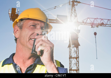Worker using walkie talkie on site