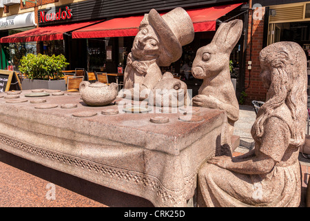 The Mad Hatter's Tea Party depicted in a statue in Golden Square Warrington shopping centre. Stock Photo