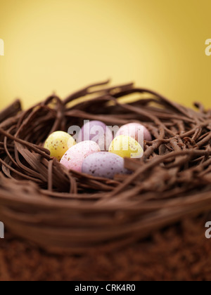 Close up of chocolate eggs in nest Stock Photo