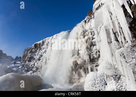 Waterfall and icicles on cliffs Stock Photo