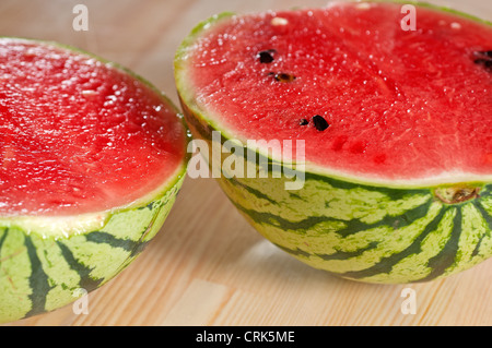fresh ripe watermelon sliced on a wood table  Stock Photo