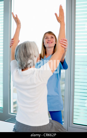 Doctor examining womans arms in office Stock Photo