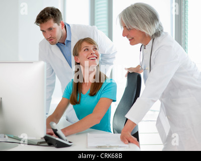 Doctors talking to receptionist Stock Photo