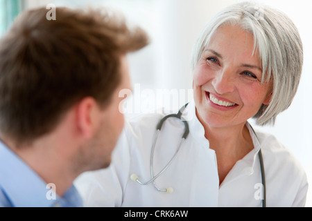 Doctor talking to man in office Stock Photo