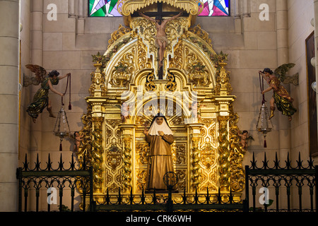 Ornate golden altar in the Almudena Cathedral, Madrid, Spain. Stock Photo