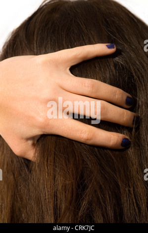Young woman runs her hands through her hair. Stock Photo