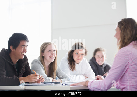 Teacher talking to students in class Stock Photo