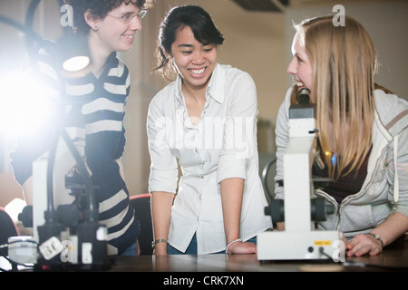 Students using microscope in lab Stock Photo