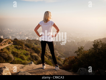 Woman overlooking view from hilltop