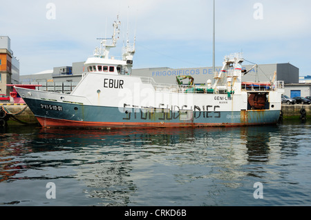 Fishing ship tied to the docks with an environmental graffiti on the hull. Vigo, Galicia, Spain Stock Photo