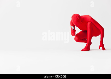 Woman in bodysuit with magnifying glass Stock Photo