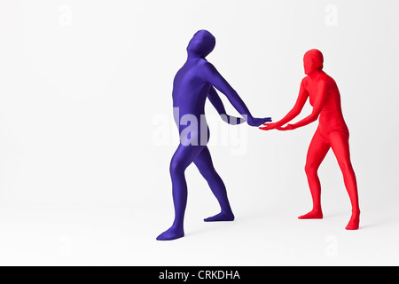 Couple in bodysuits with invisible globe Stock Photo