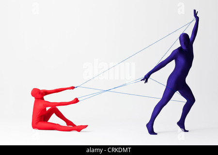 Couple in bodysuits playing with string Stock Photo