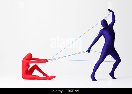 Couple in bodysuits playing with string Stock Photo