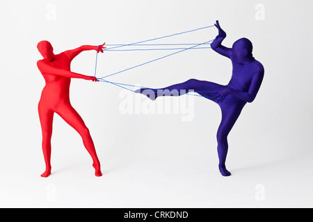 Couple in bodysuits playing with string Stock Photo