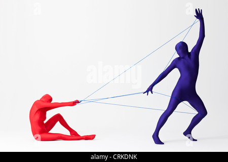 Couple in bodysuits playing with string Stock Photo