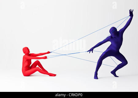 Couple in bodysuits playing with string Stock Photo