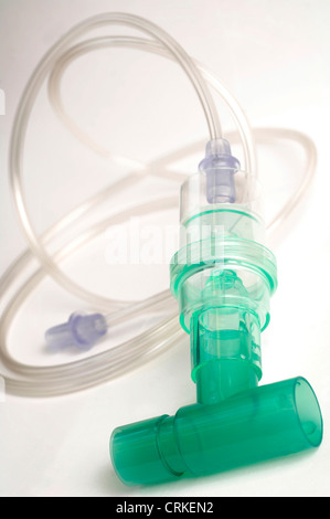 Close up of a connector tube, commonly used to connect facemasks to oxygen cylinders and similar equiment. The green section of the connector tube houses two valves, one which allows air to move up the tube and into the facemask when the patient breathes in. The second valve allows air to move out when the patient exhales. The device can act as an indicator Stock Photo