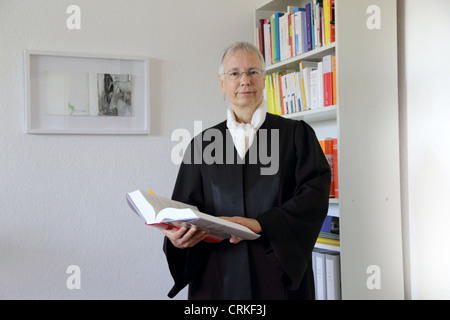 Lawyer reading text book in office Stock Photo