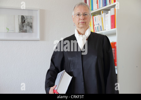 Lawyer holding text book in office Stock Photo