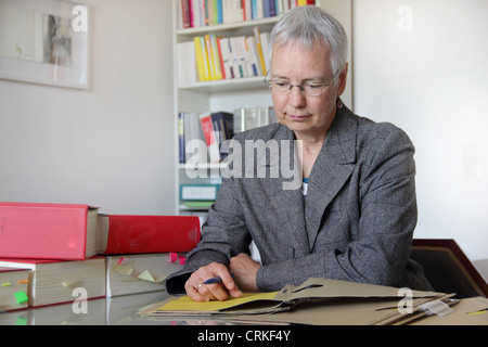 Lawyer reading notes in office Stock Photo