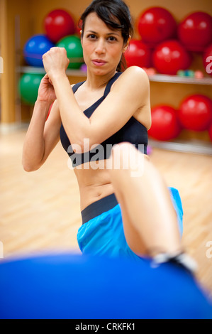 Woman kick boxing in gym Stock Photo