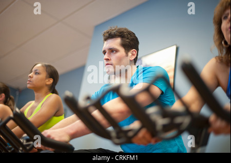 People using spin machines in gym Stock Photo - Alamy