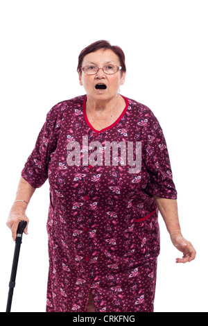 Portrait of surprised elderly woman with walking stick, isolated on white background. Stock Photo