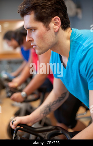 People using spin machines in gym Stock Photo - Alamy