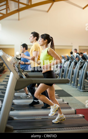 People using treadmills in gym Stock Photo