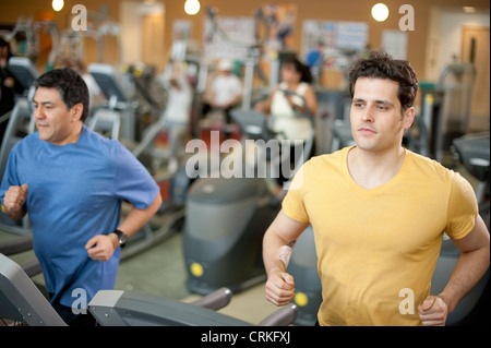 Men using treadmills in gym Stock Photo