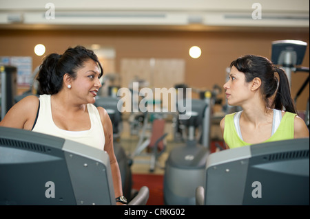 Women using treadmills in gym Stock Photo