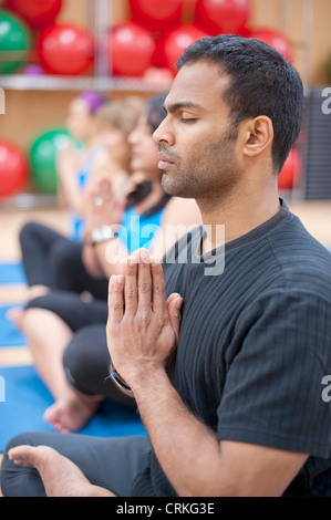 Man practicing yoga in studio Stock Photo