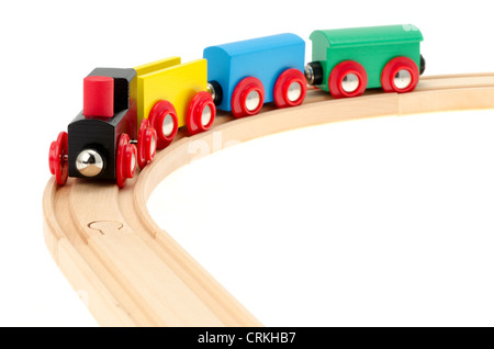 A child's wooden toy train and track - shallow depth of field, studio shot with a white background Stock Photo