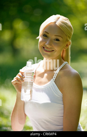 A young blonde drinking a bottle of water Stock Photo