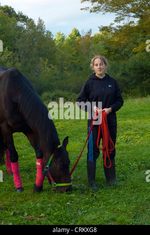 Teenage girl holding her quarter horse with rope, Yarmouth Maine, USA Stock Photo