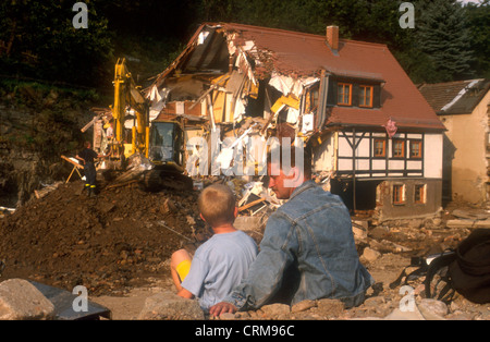 Father and son look to demolition of her house after the flood in Saxony Stock Photo