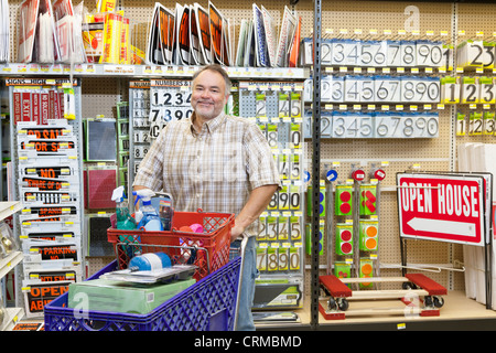 Portrait of a mature man with shopping cart in hardware store Stock Photo