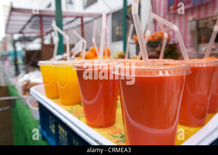 Close-up of fruit juices on display at market stall Stock Photo