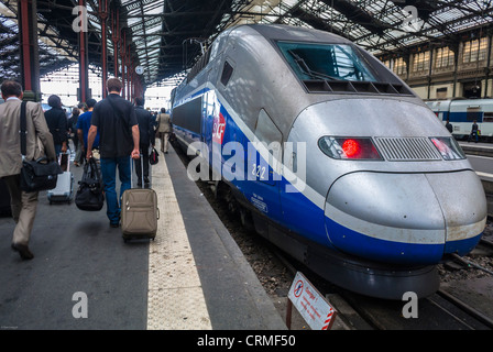 Paris, France, Small Crowd People, From Behind, Walking Away, Tourists Traveling on Quay inside SNCF Train Station, 'T.G.V. Bullet Train', 'Gare de Ly-on', high speed train Platform Stock Photo