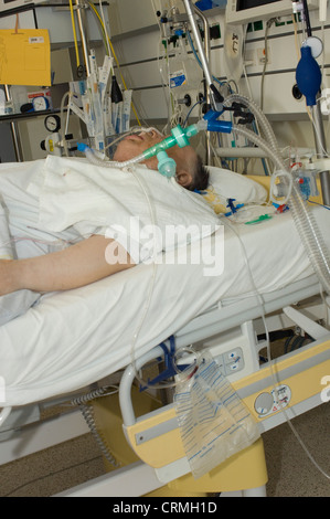 An elderly woman patient under intensive care on a life support system. Stock Photo
