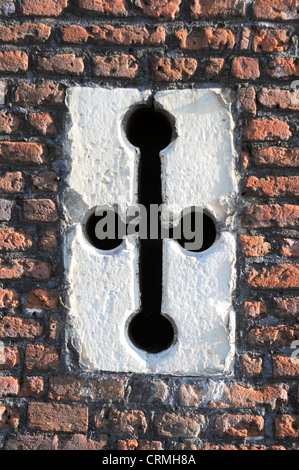 An archers slit in old wall of English Tudor building Stock Photo