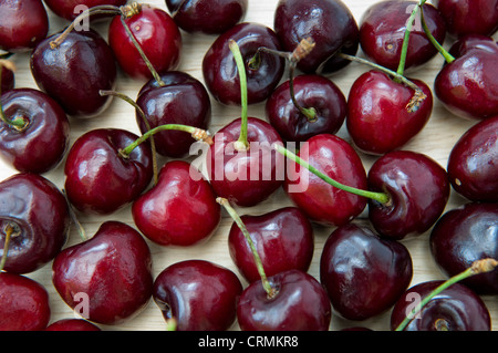 Full frame image of ripe cherries on wooden chopping board Stock Photo
