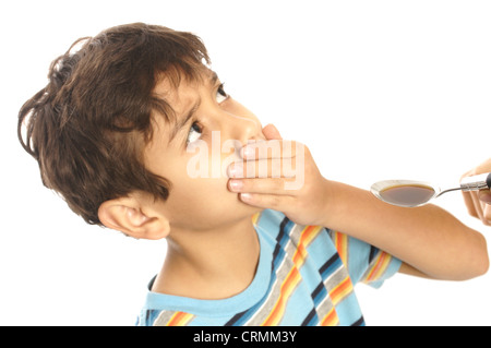 A young boy refusing to take cough syrup from his mother Stock Photo