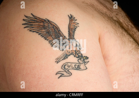 Close-up of a eagle tattoo with Chloe name on the arm of a  man. Stock Photo