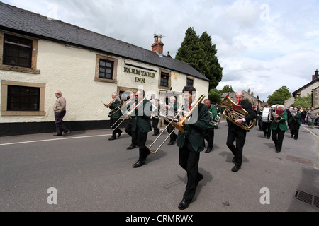 The Village Band Marching Through the Derbyshire Village of Youlgreave for the Blessing of the Well Dressings Stock Photo