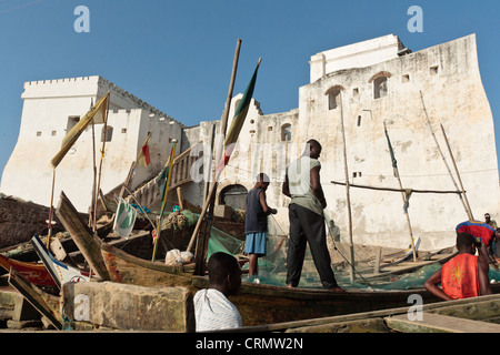 Men on fishing boats near Cape Coast castle, Cape Coast, Ghana Stock Photo