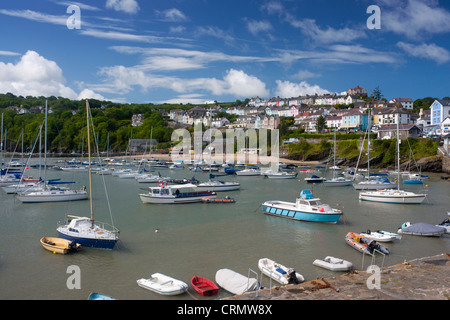 New Quay harbour at high tide with boats and colourful terraced houses on hill behind Ceredigion Mid Wales UK Stock Photo