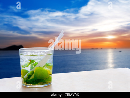 Ibiza cala Conta Conmte sunset with Mojito drink cocktail Stock Photo